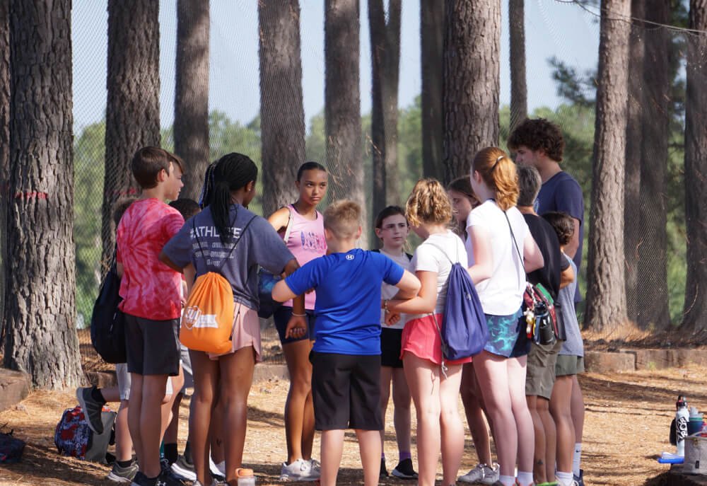 Kids participating in ground-based camp activities